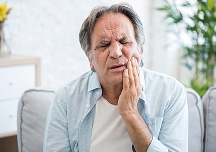 Closeup of man experiencing toothache at home