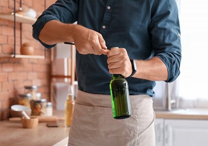 Man opens bottle with opener?