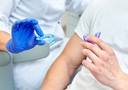 Dentist shows patient mouthguards