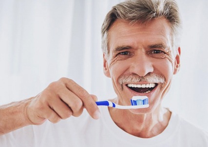 older man about to brush teeth 