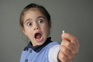 Young girl shocked at her knocked-out tooth