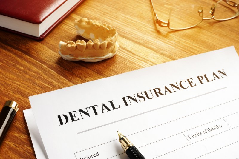 a dental insurance plan form on a wooden table