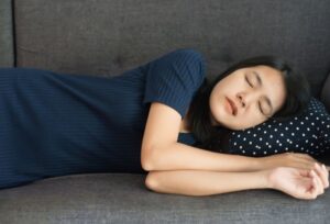 Woman grinding her teeth while sleeping on couch